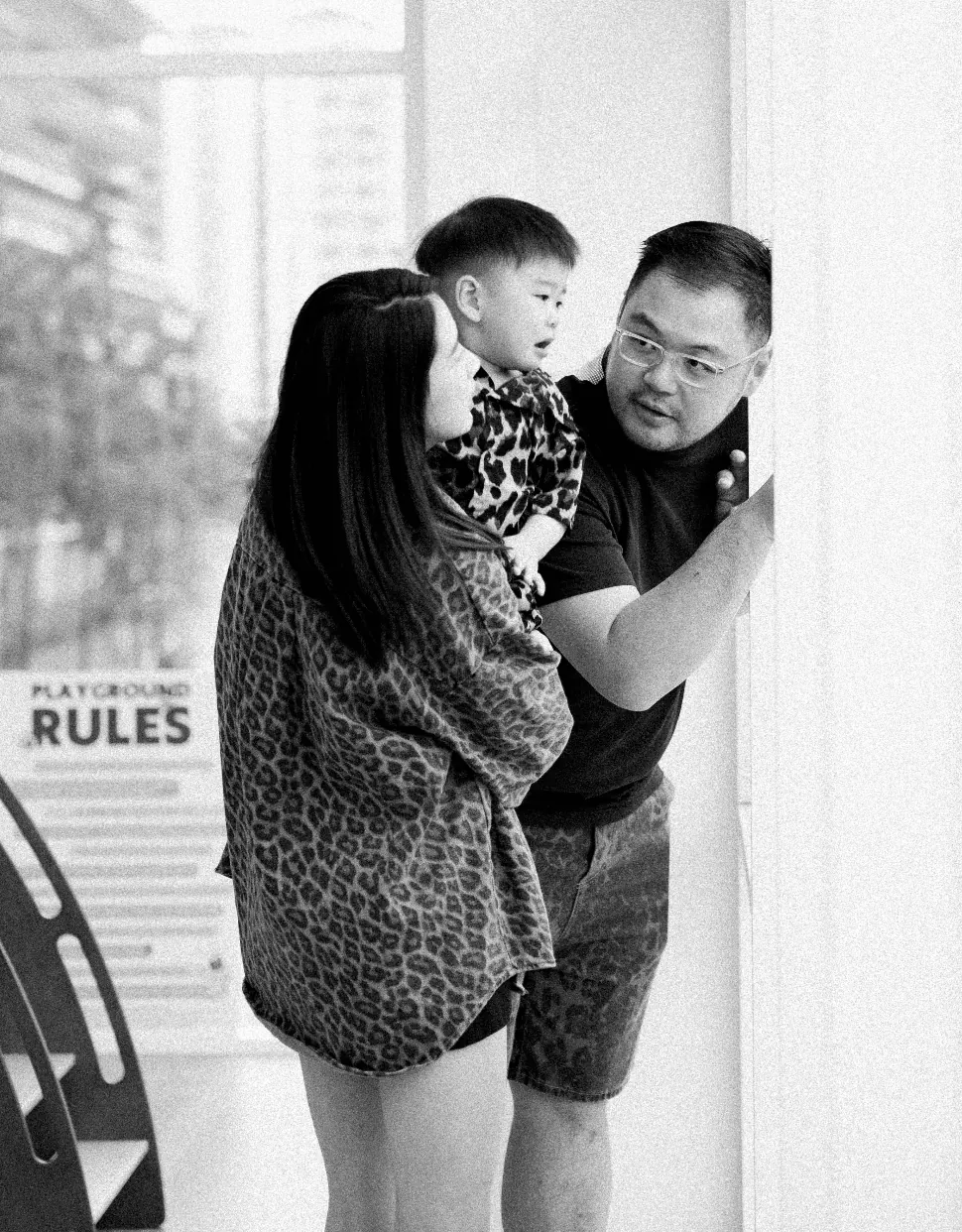 A parent crouched beside their toddler at Naru Play Café, calm and unhurried, while play carries on around them.